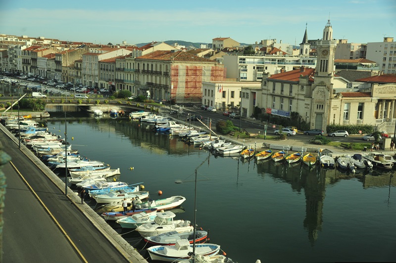 View of Sete waterfront on the Mediterranean in France with fishing boats and local architectural highlights